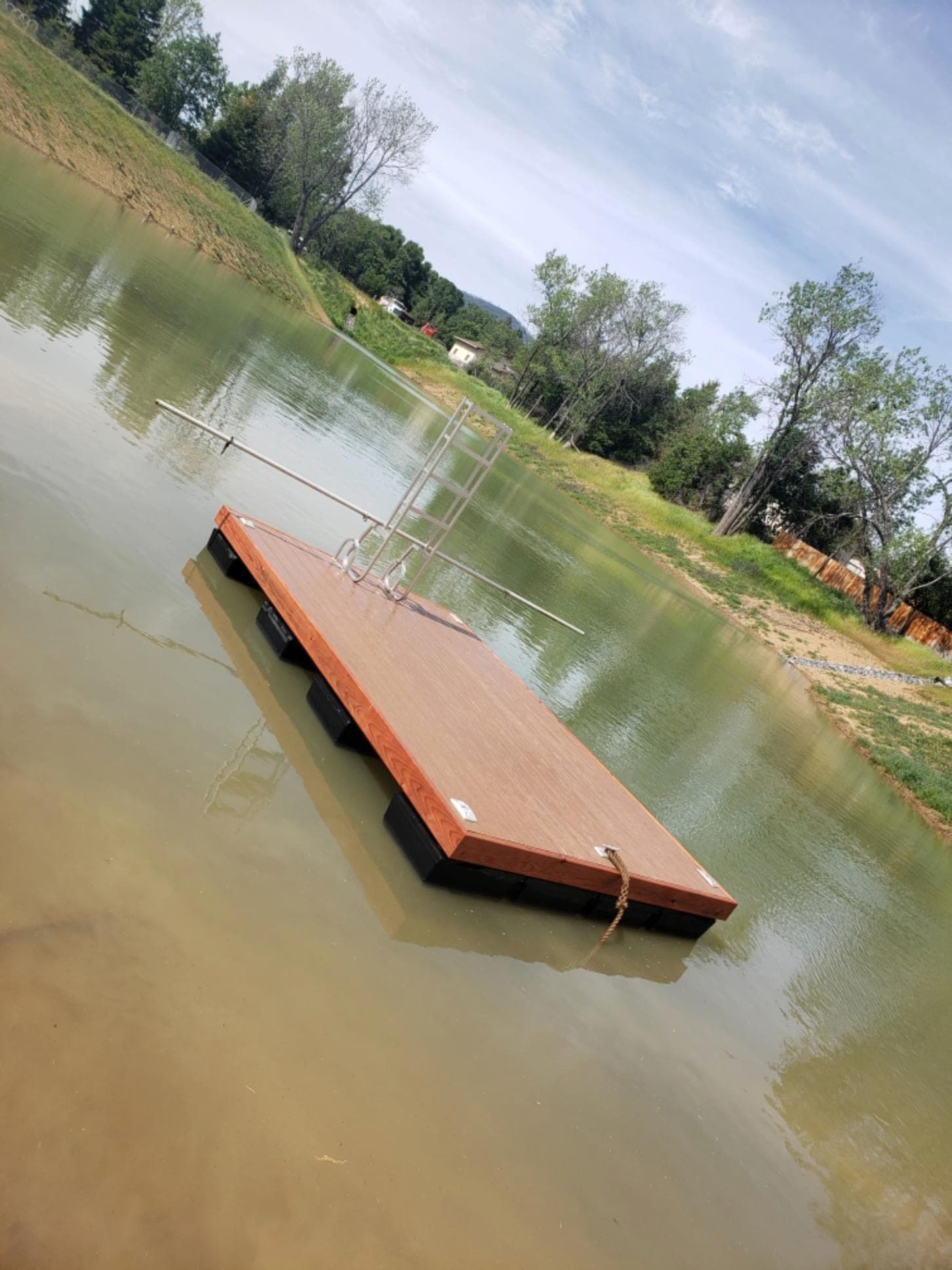 Custom redwood-topped floating dock built by RLS Custom Carpentry for a client's pond in Mendocino County, CA