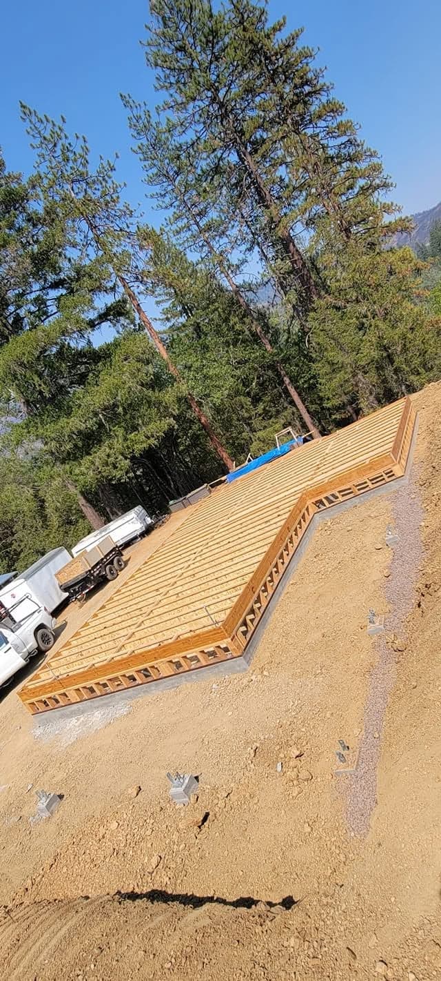Engineered I-joist subfloor platform framed over a new foundation on a sloped wooded lot by RLS Custom Carpentry in Mendocino County, California