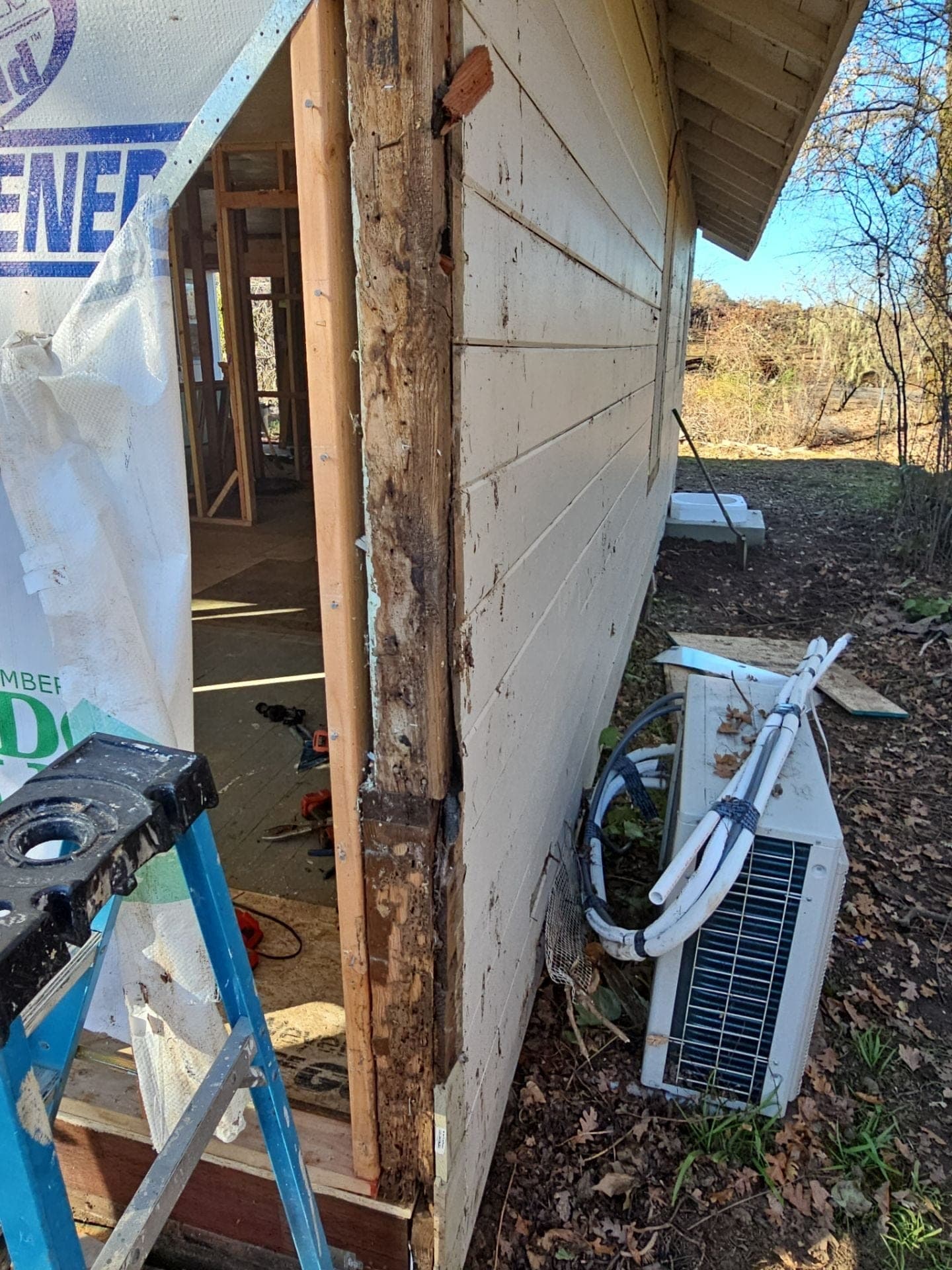 Exterior wall corner with original siding removed to expose framing where a new addition ties into the existing home, RLS Custom Carpentry, Mendocino County, CA