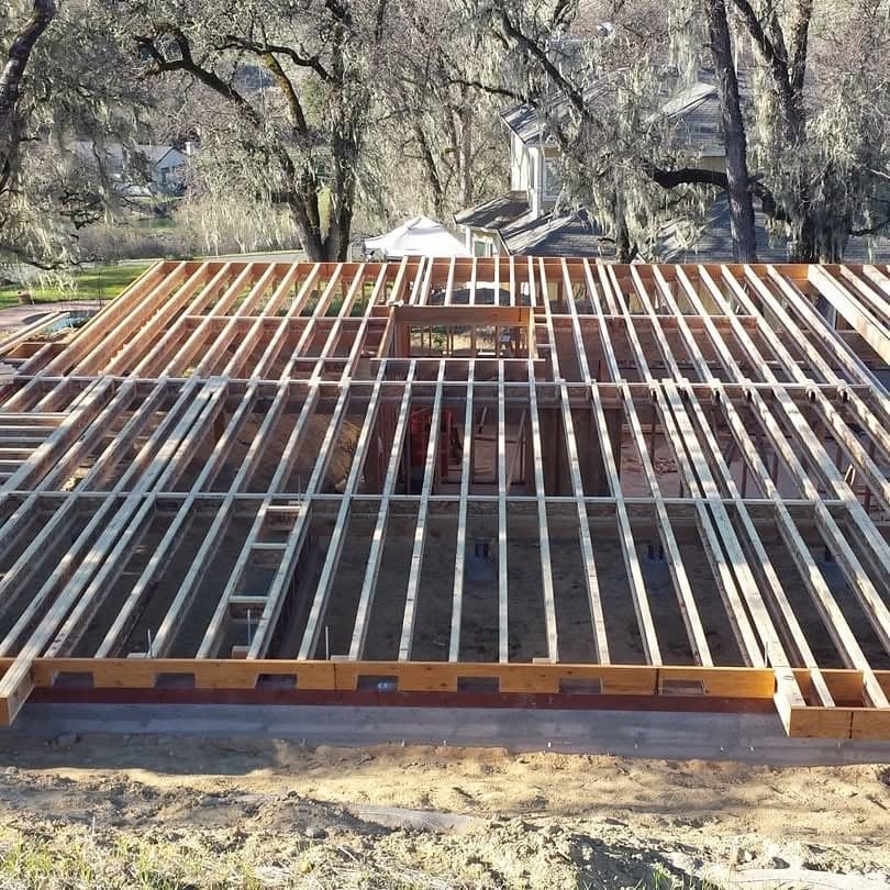 New home floor joist framing over a poured concrete foundation with oak trees, structural carpentry by RLS Custom Carpentry in Mendocino County, CA