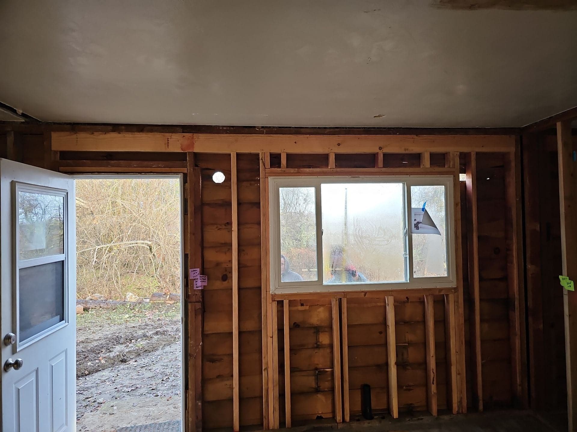 Interior remodel with wall opened to the studs, a newly installed slider window and exterior door by RLS Custom Carpentry in Mendocino County, CA