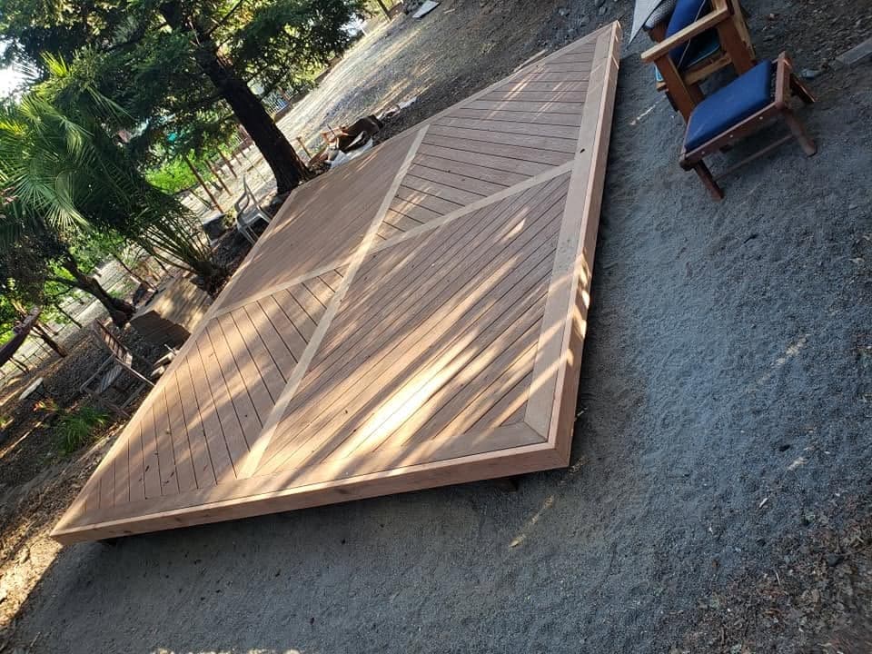 Low-profile custom redwood platform deck with intricate diagonal chevron decking pattern and mitered border, craftsmanship by RLS Custom Carpentry in Mendocino County CA