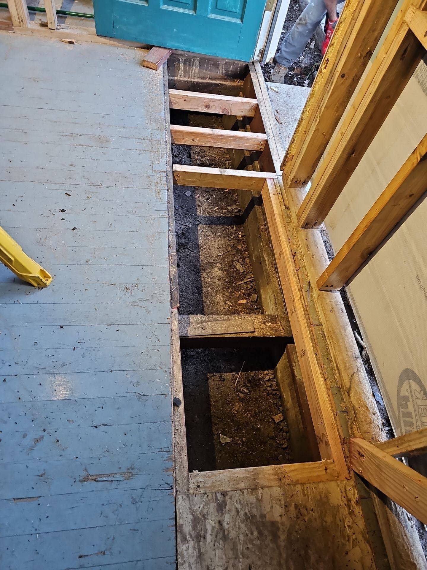 New floor joists framed in over the crawlspace at an interior doorway during a floor rebuild by RLS Custom Carpentry in Mendocino County, CA