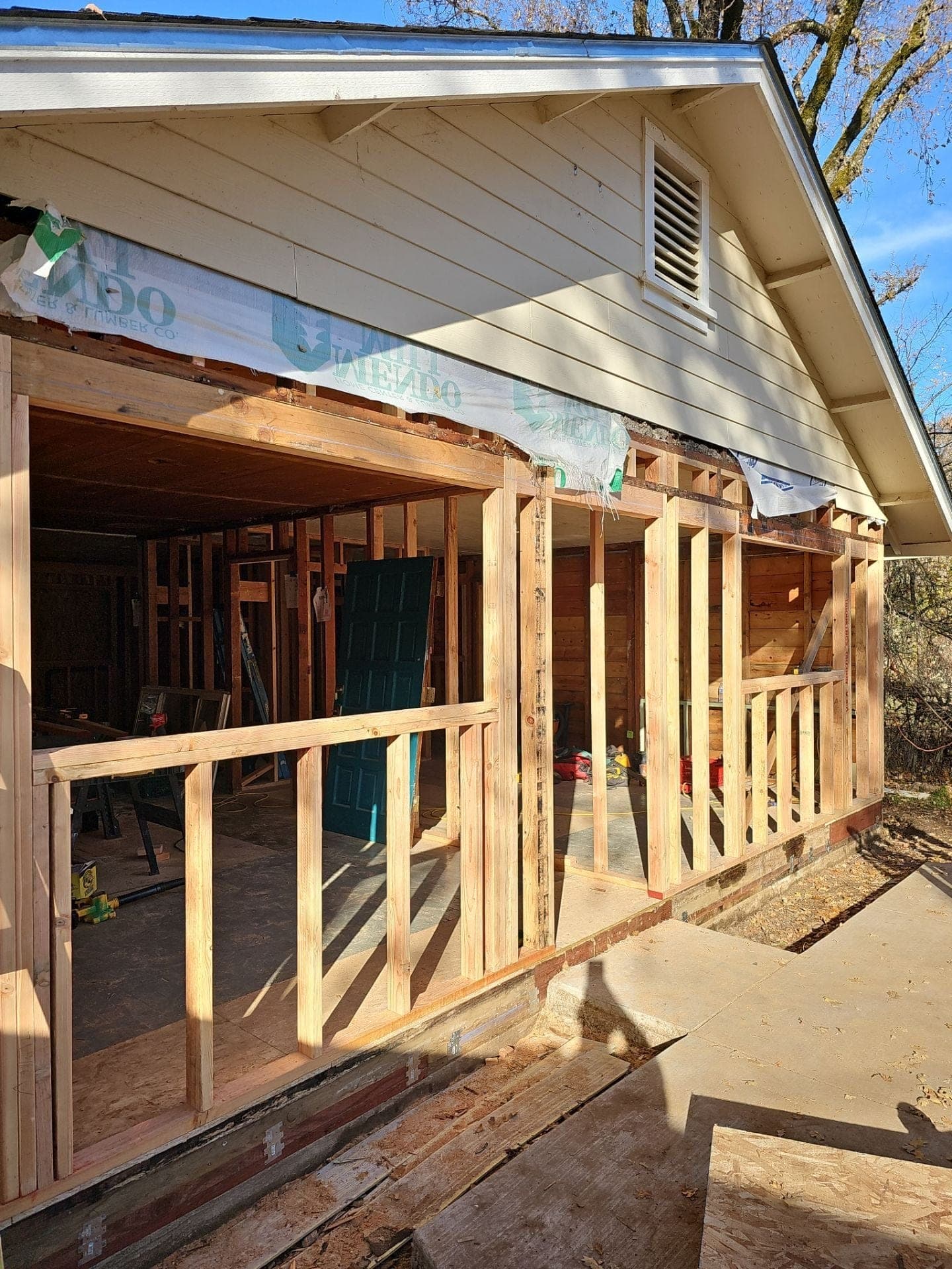 New wood stud-wall framing for a porch addition tied into an existing home, built by RLS Custom Carpentry in Mendocino County, CA