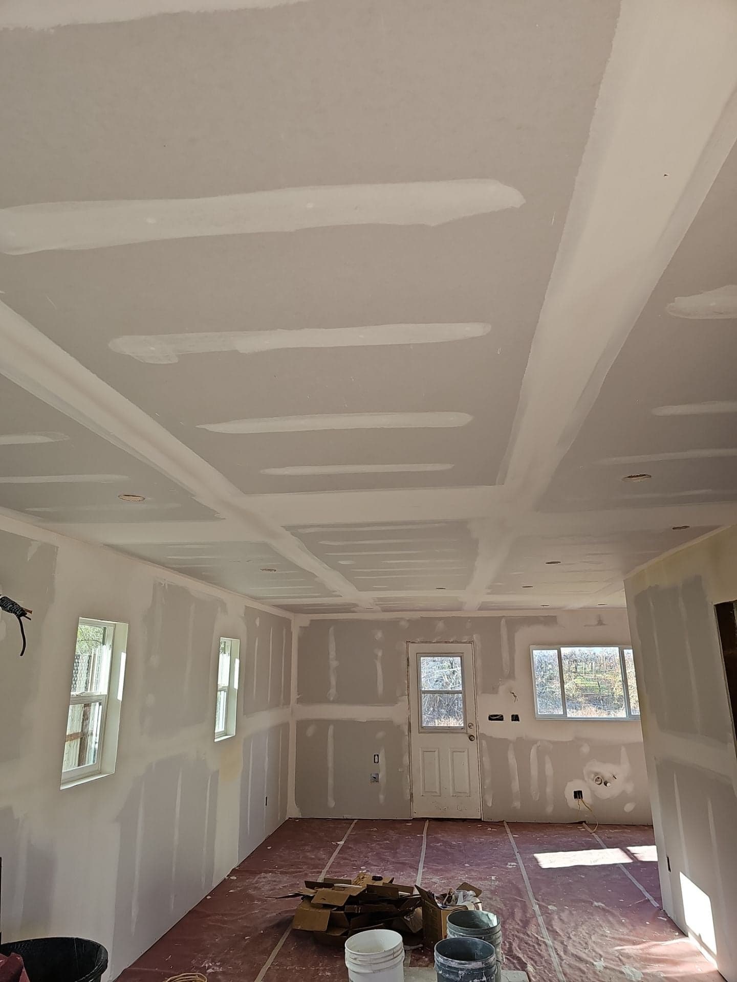 Remodeled room at 5160 Burke Hill Rd in Mendocino County with new drywall hung and taped on walls and ceiling by RLS Custom Carpentry