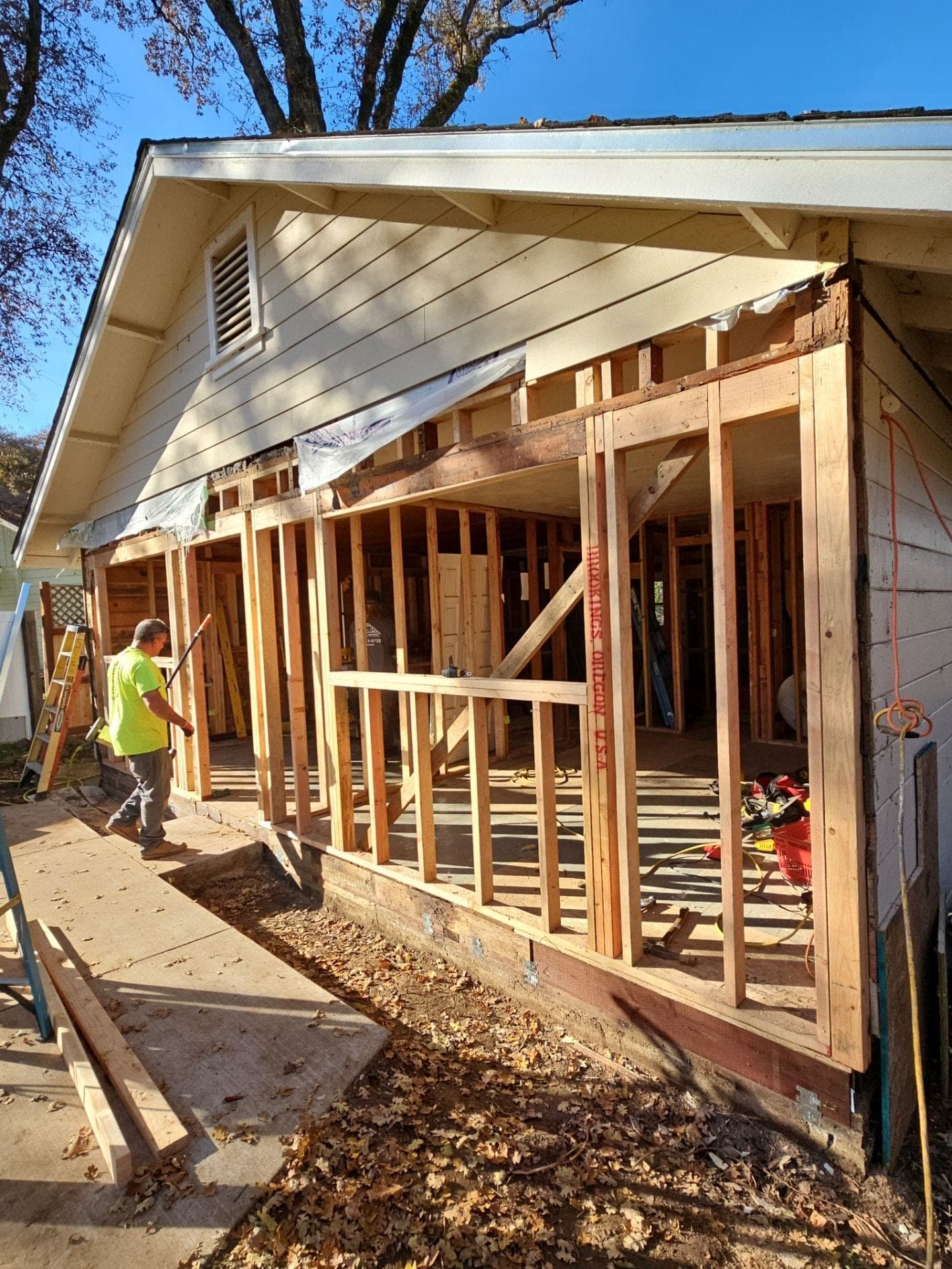 RLS Custom Carpentry crew member working on the framed skeleton of a porch addition tied into an existing home in Mendocino County, CA